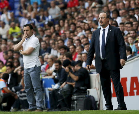 Real Madrid's coach Rafa Benitez (R) and Espanyol's coach Sergio Gonzalez look to the pitch during their Spanish first division soccer match, near Barcelona, Spain, September 12, 2015. REUTERS/Albert Gea