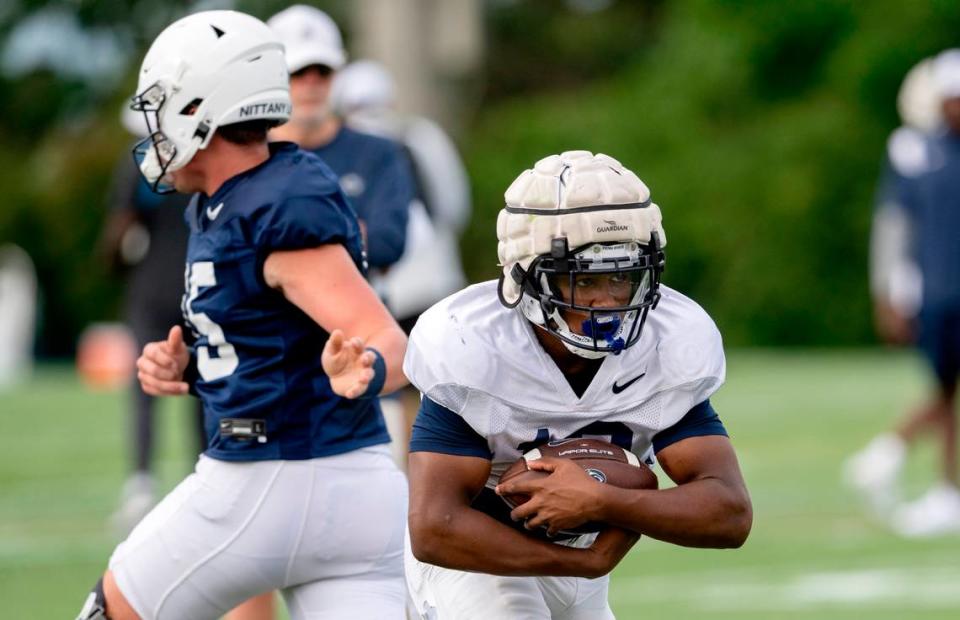 Penn State running back Nicholas Singleton runs with the ball during practice on Wednesday, Aug. 10, 2022.