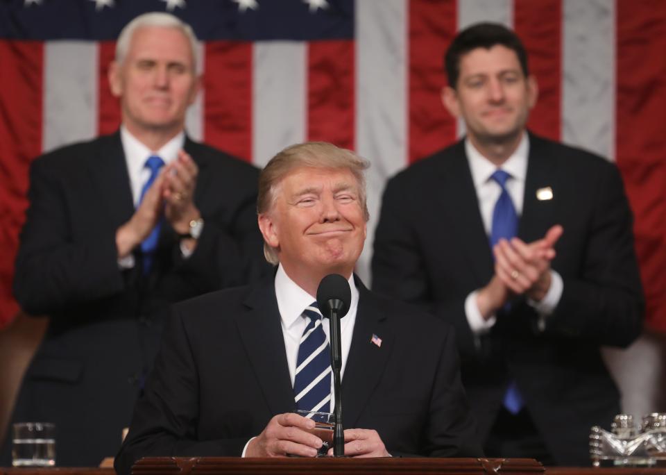 US Vice President Mike Pence (L) and Speaker of the House Paul Ryan (R) applaud as US President Donald J. Trump (C) arrives to deliver his first address to a joint session of Congress from the floor of the House of Representatives in Washington, DC, USA, 28 February 2017.  / AFP / POOL / JIM LO SCALZO        (Photo credit should read JIM LO SCALZO/AFP/Getty Images)