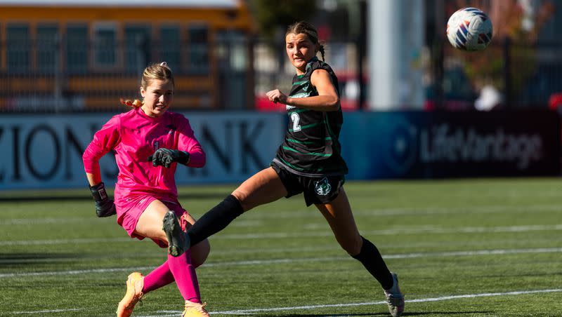Green Canyon’s Austin Miller, right, and Ridgeline’s Lily Loyet look at the ball during the 4A girls soccer semifinals at Zions Bank Stadium in Herriman on Monday, Oct. 16, 2023.