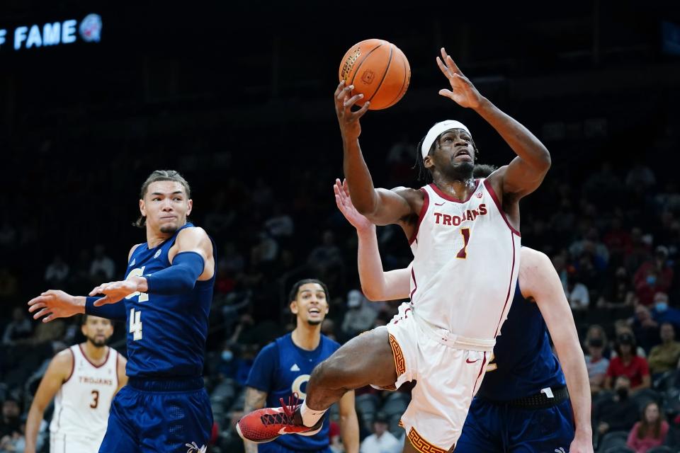 Southern California forward Chevez Goodwin (1) drives to the basket after getting past Georgia Tech guard Jordan Usher (4) during the first half of an NCAA college basketball game at the Jerry Colangelo Classic Saturday, Dec. 18, 2021, in Phoenix. (AP Photo/Ross D. Franklin)