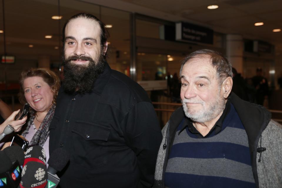 Canadian Greenpeace activist Alexandre Paul smiles as he meets the media with his parents after arriving in Montreal