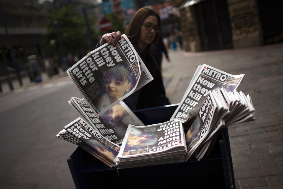 <p>A woman picks a newspaper reporting the news on the suicide attack at a concert by Ariana Grande that killed more than 20 people as it ended Monday night in central Manchester, Britain, May 24, 2017. (Photo: Emilio Morenatti/AP) </p>