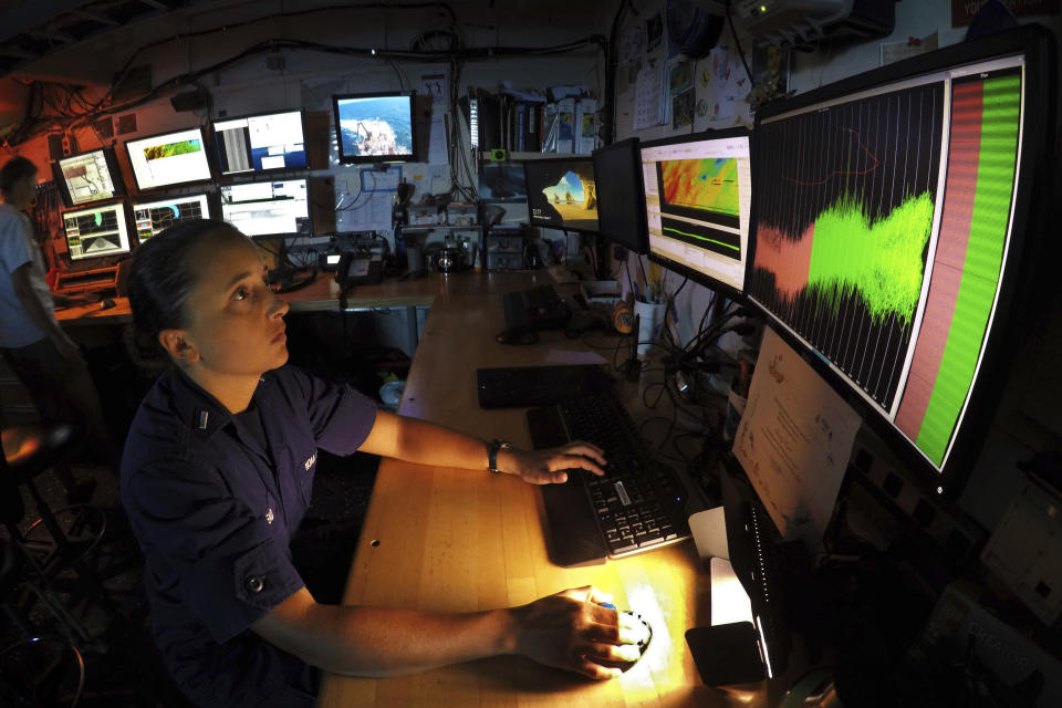 Marybeth Head, who also serves as the vessel operations coordinator of Gray's Reef National Marine Sanctuary, works on a habitat mapping project of the reef in the dry lab aboard the NOAA Ship Nancy Foster, about 20 miles off the coast of Georgia on Wednesday, Aug. 7, 2019. The federal research vessel is full of scientists conducting research on subjects ranging from whether invasive lionfish are present to how changing ocean conditions are affecting coral species. (AP Photo/Robert F. Bukaty)