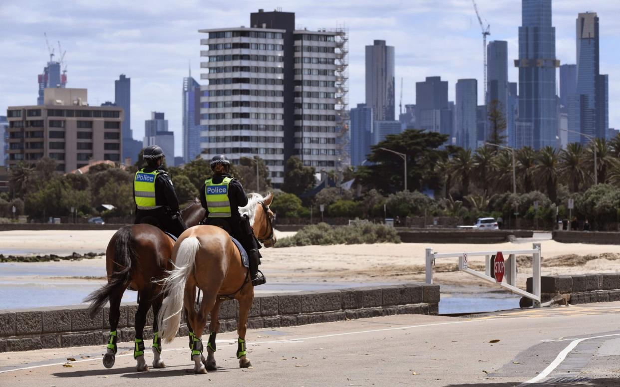 Police patrol on the St Kilda esplanade in Melbourne as the city exits lockdown after more than 100 days - AFP