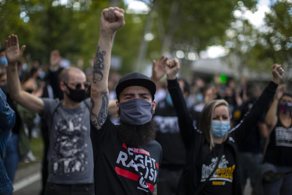 People take part in a protest to demand more resources for public health system and against social inequality in the southern neighbourhood of Vallecas in Madrid, Spain, Sunday, Sept. 27, 2020. Residents in a lockdown district of Madrid protested outside the Madrid Regional Government that local health services needed to be reinforced during the ongoing COVID-19 outbreak. (AP Photo/Manu Fernandez)