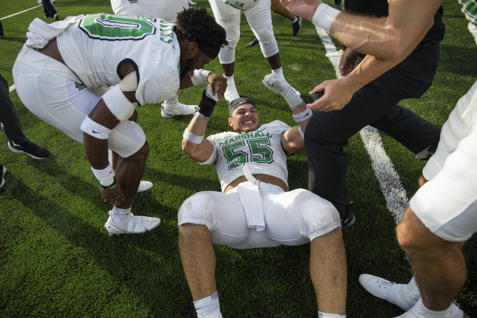 Marshall's Owen Porter (55) celebrates with teammates after the team defeated Notre Dame in an NCAA college football game Saturday, Sept. 10, 2022, in South Bend, Ind. Marshall won 26-21. (Sholten Singer/The Herald-Dispatch via AP)