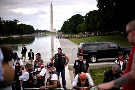 Bikers operating as security personnel watch and listen as Republican U.S. presidential candidate Donald Trump addresses motorcyclists participating in Rolling Thunder, the annual ride around Washington Mall to raise awareness for prisoners of war and soldiers still missing in action, in Washington, U.S., May 29, 2016. REUTERS/James Lawler Dugga8