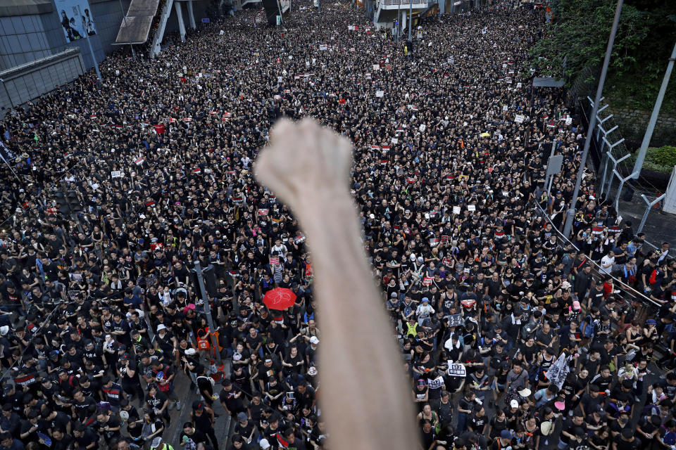 FILE - In this June 16, 2019, file photo, protesters march on the streets against an extradition bill in Hong Kong. Hong Kong's protest movement has reached a moment of reckoning after protesters occupying the airport held two mainland Chinese men captive, and pro-democracy lawmakers and fellow demonstrators question whether the whole operation has gone too far. (AP Photo/Vincent Yu, File)