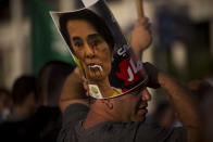 <p>A member of the Islamic Movement in Israel, a political movement for Arab Muslims inside Israel, displays a defaced poster of Myanmar’s State Counsellor Aung San Suu Kyi during a demonstration to condemn Myanmar’s treatment of the Muslim Rohingya minority, in front of the embassy of Myanmar, in Tel Aviv, Israel, Monday, Sept. 11, 2017. Protest leader Ibrahim Sarsour said the crowd came to condemn what he called “atrocities” committed by the Myanmar government. (Photo: Oded Balilty/AP) </p>
