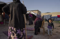 Bedouins gather outside their tent at the West Bank hamlet of Khan al-Ahmar, Sunday, Jan. 22, 2023. The long-running dispute over the West Bank Bedouin community of Khan al-Ahmar, which lost its last legal protection against demolition four years ago, resurfaced this week as a focus of the frozen Israeli-Palestinian conflict. Israel's new far-right ministers vow to evacuate the village as part of a wider project to expand Israeli presence in the 60% of the West Bank over which the military has full control. Palestinians seek that land for a future state. (AP Photo/Oded Balilty)