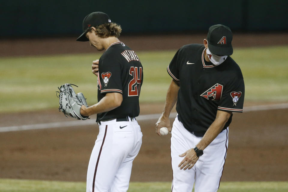 Arizona Diamondbacks manager Torey Lovullo, right, takes the baseball from starting pitcher Luke Weaver during the fifth inning of the team's baseball game against the Los Angeles Dodgers on Saturday, Aug. 1, 2020, in Phoenix. (AP Photo/Ross D. Franklin)