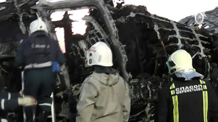 A still image, taken from a video footage and released by Russia's Investigative Committee on May 6, 2019, shows members of emergency services at the scene of an incident involving an Aeroflot Sukhoi Superjet 100 passenger plane at Moscow's Sheremetyevo airport, Russia. The Investigative Committee of the Russian Federation/Handout via REUTERS