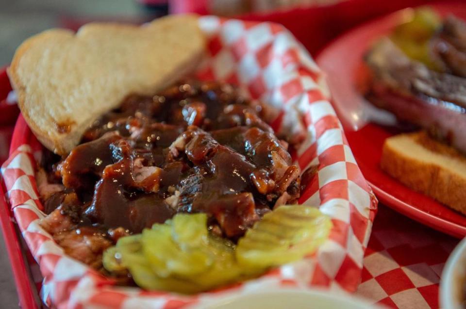 An order of burnt ends is served on white bread with a side of pickles at P Moore & Moore BBQ.