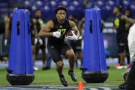 Wisconsin running back Jonathan Taylor runs a drill at the NFL football scouting combine in Indianapolis, Friday, Feb. 28, 2020. (AP Photo/Michael Conroy)