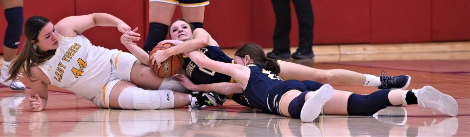 Stephenville's Marin Copeland, center, and Lucy Espinoza, right, battle Snyder's Arynne Vasquez for a loose ball in the second half.