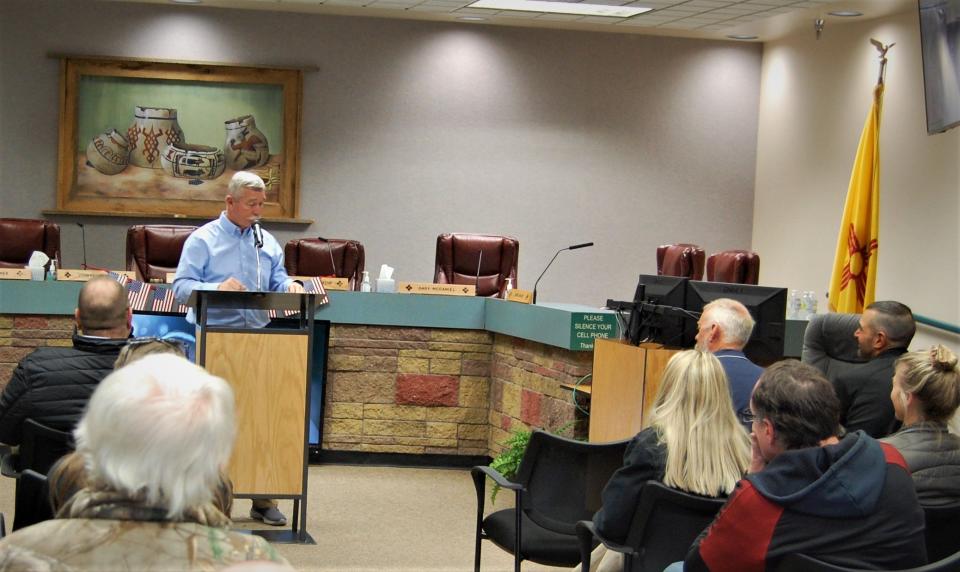 San Juan County Commissioner Steve Lanier, left, welcomes the members of Team Guardian to a celebration in their honor Feb. 16 at the County Administration Building in Aztec.