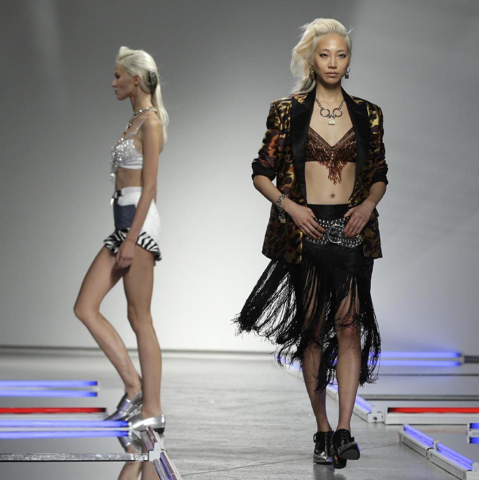 The Rodarte Spring 2014 collection is modeled during Fashion Week in New York, Tuesday, Sept. 10, 2013. (AP Photo/Seth Wenig)