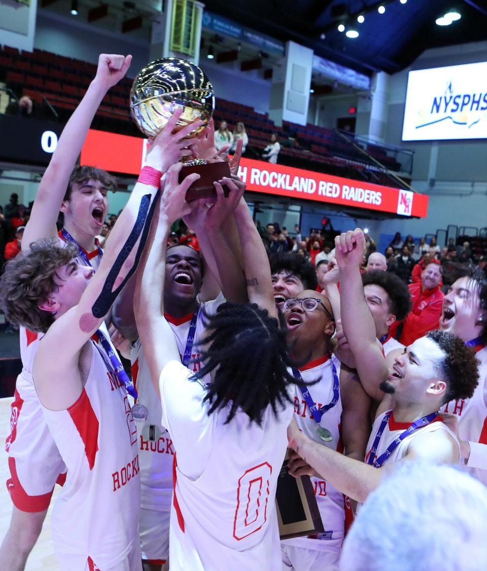 North Rockland players celebrate with the Gold Ball after defeating Scarsdale 52-40 in the boys Section 1 Class AA championship at the Westchester County Center in White Plains March 5, 2023. 