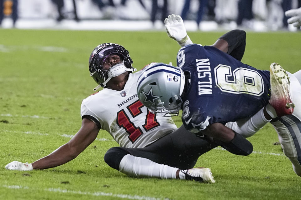Tampa Bay Buccaneers wide receiver Russell Gage (17) is hit Dallas Cowboys safety Donovan Wilson (6) during the second half of an NFL wild-card football game, Monday, Jan. 16, 2023, in Tampa, Fla. Tampa Bay Gage was injured on the plaY (AP Photo/Chris Carlson)
