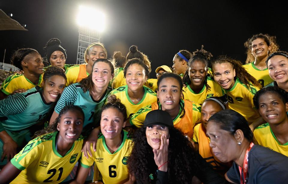 Cedella Marley (C bottom) poses with Jamaica's Women's national soccer team, the  