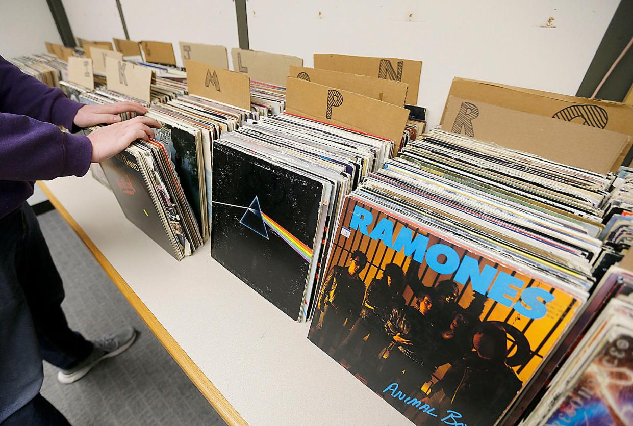 WRDL's Derek Wood looks through the stacks of vinyl records as Ashland University prepares for its annual Vinylthon in 2023. This year's event is Saturday and Sunday.