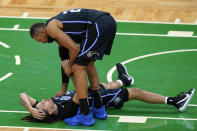 Orlando Magic center Khem Birch (24) checks on Cole Anthony, who had landed on the floor during the second half of the team's NBA basketball game against the Boston Celtics, Friday, Jan. 15, 2021, in Boston. (AP Photo/Elise Amendola)