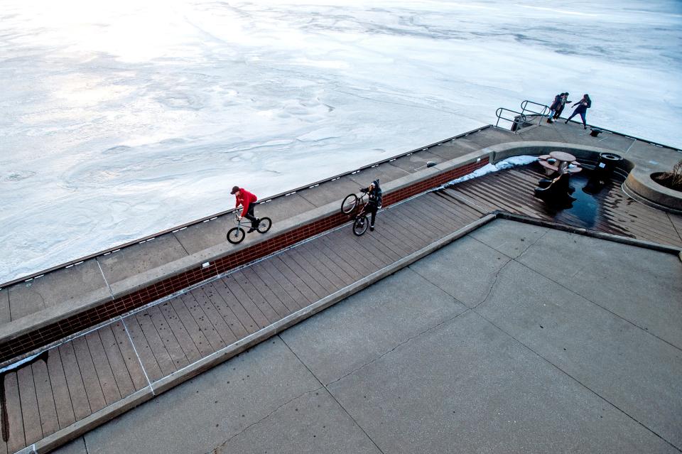 Locals take photos and rides bikes along the Erie Bayfront overlooking the frozen bay on Feb. 21, 2022 near downtown Erie. Benjamin Chambers/Erie Times-News.