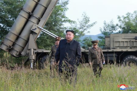 North Korean leader Kim Jong Un attends the testing of a super-large multiple rocket launcher in North Korea