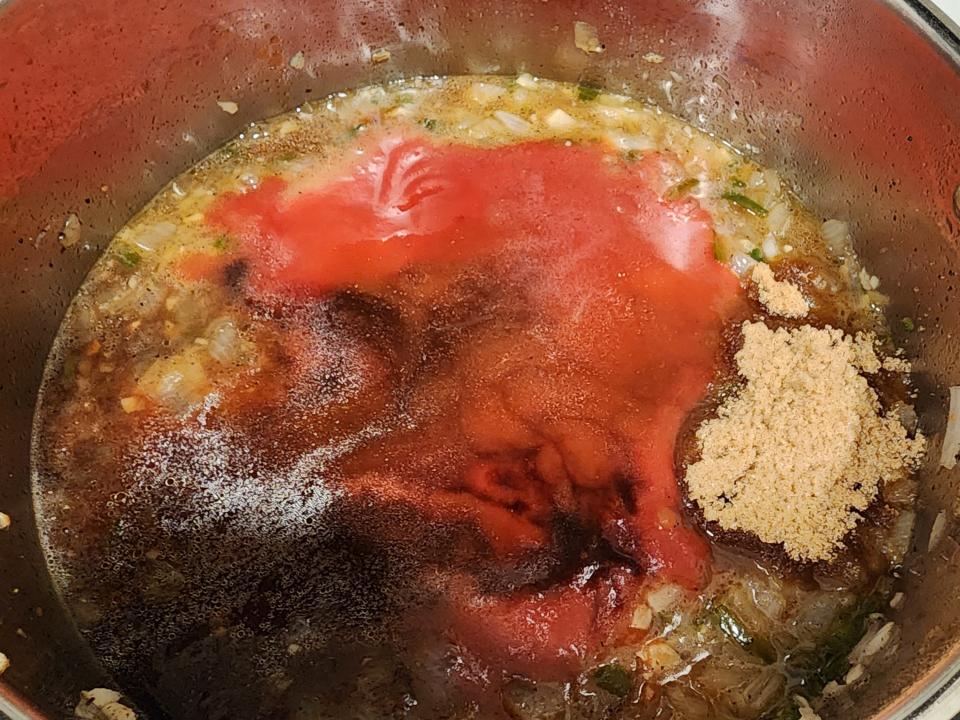 Barbecue sauce being mixed in a pot.