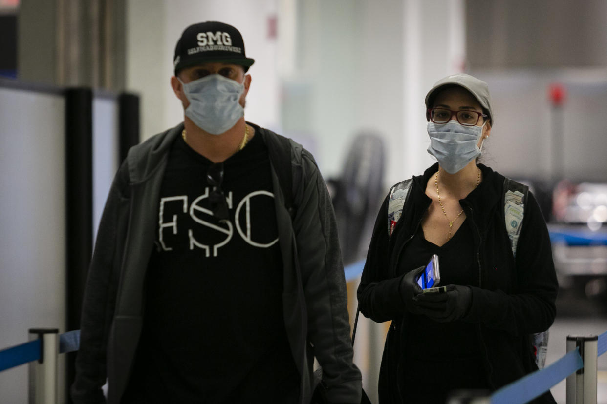 FLORIDA, USA - MARCH 29: Passengers are seen wearing protective masks and gloves at Miami International Airport in Miami, Florida, United States on March 29, 2020. (Photo by Eva Marie Uzcategui Trinkl/Anadolu Agency via Getty Images)