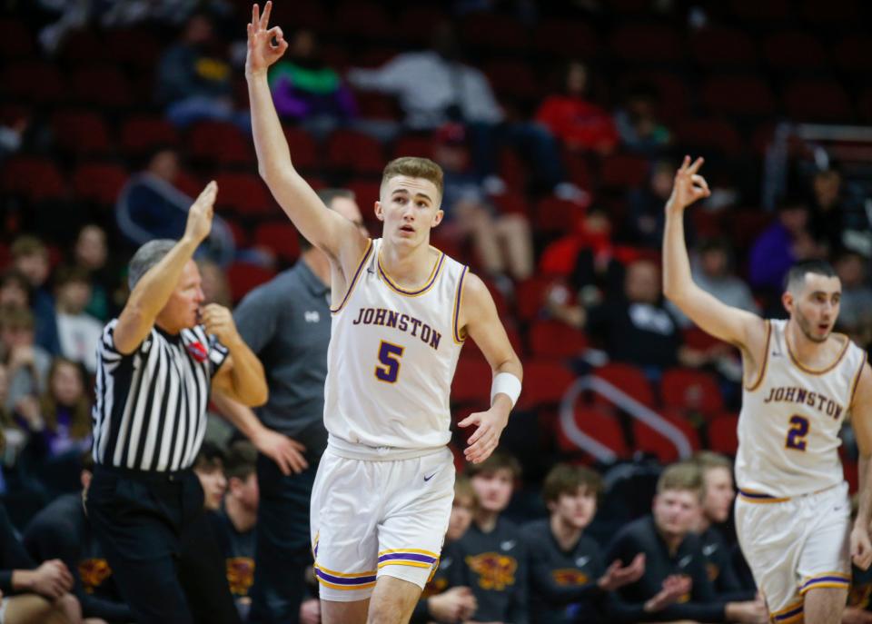 Johnston's Steven Kramer holds up the three sign after hitting a three-pointer against Ankeny during the Iowa high school boys basketball tournament at Wells Fargo Arena in Des Moines on Wednesday, March 9, 2022.
