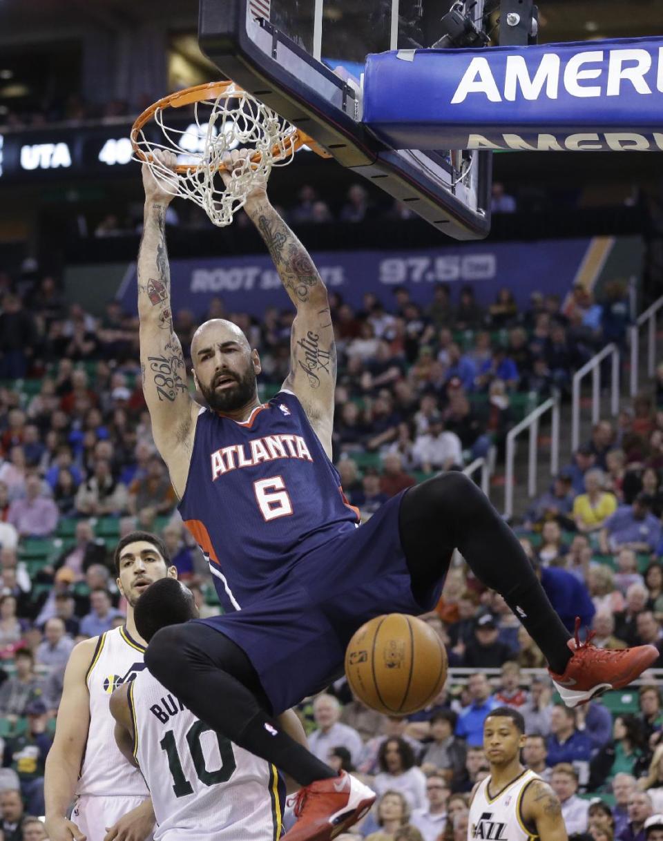 Atlanta Hawks' Pero Antic (6), of Macedonia, dunks the ball against Utah Jazz's Enes Kanter, rear, and Utah Jazz's Alec Burks (10) in the second quarter during an NBA basketball game Monday, March 10, 2014, in Salt Lake City. (AP Photo/Rick Bowmer)