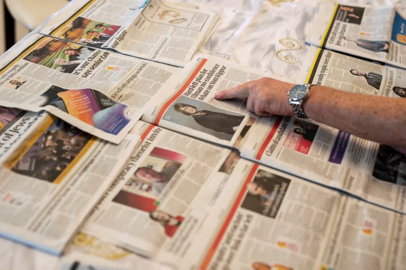 British immigrant to Israel, Harvey Seitz, points at Jewish newspapers he received from Britain, during an interview with Reuters in Ashkelon, Israel