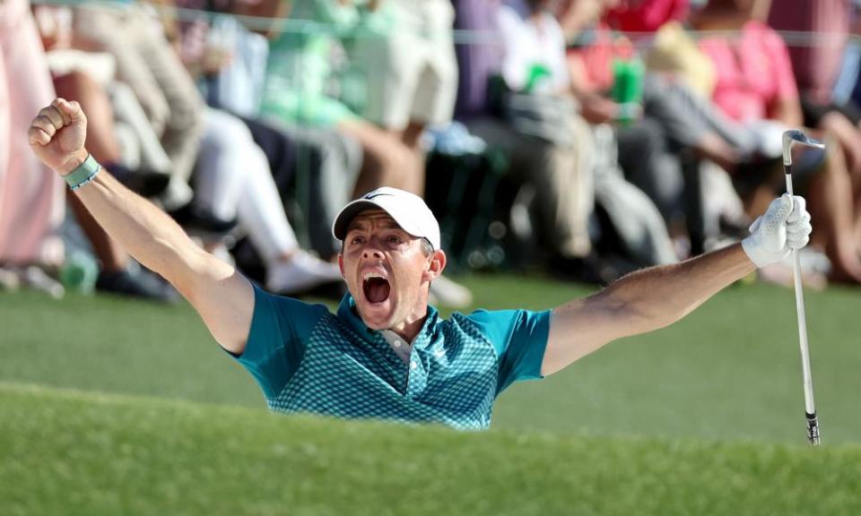 Rory McIlroy celebrates after chipping in from the bunker on the 18th.