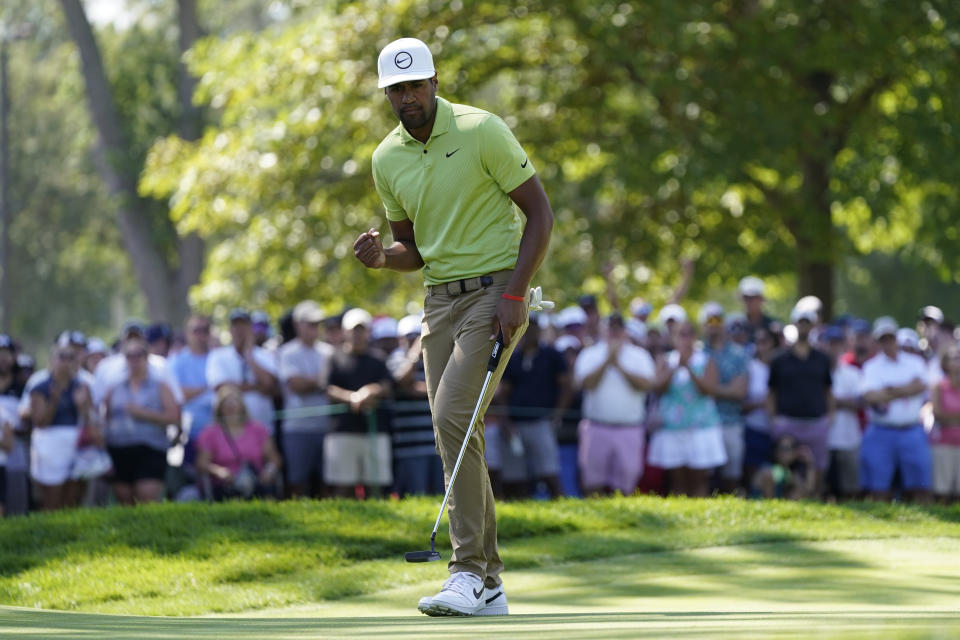 Tony Finau reacts after making his putt for par on the ninth green during the final round of the Rocket Mortgage Classic golf tournament, Sunday, July 31, 2022, in Detroit. (AP Photo/Carlos Osorio)