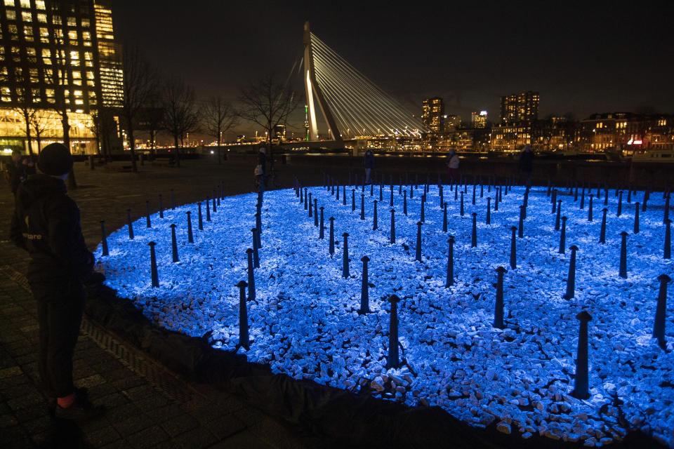 The monument Levenslicht, or Light of Life, by artist Daan Roosegaarde, consisting of 104,000 light-emitting stones for the number of Dutch Holocaust victims is unveiled in Rotterdam, Netherlands, Thursday, Jan. 16, 2020, to mark the 75th anniversary, later this month, of the liberation of Auschwitz concentration and extermination camp. (AP Photo/Peter Dejong)