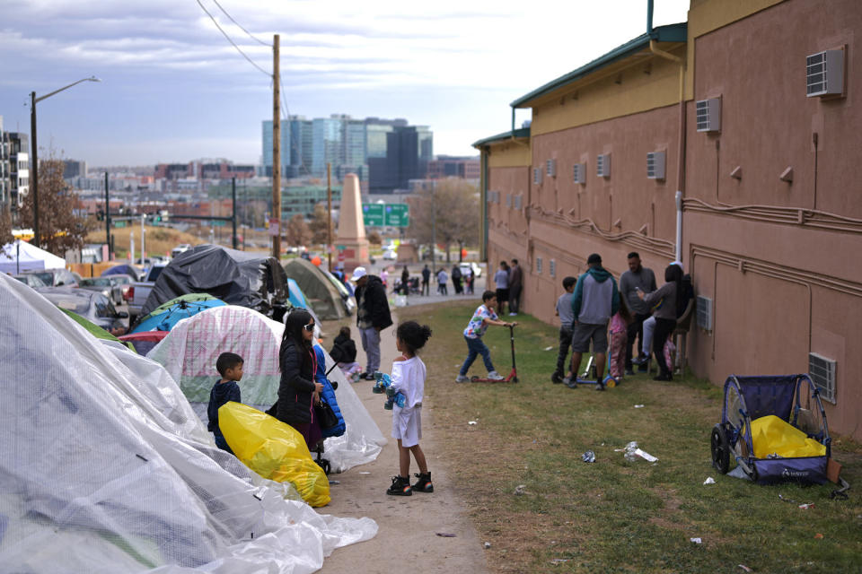 Children play between the campsite and Quality Inn Denver Downtown in Denver on Nov. 16, 2023.  (Hyoung Chang / Denver Post via Getty Images)