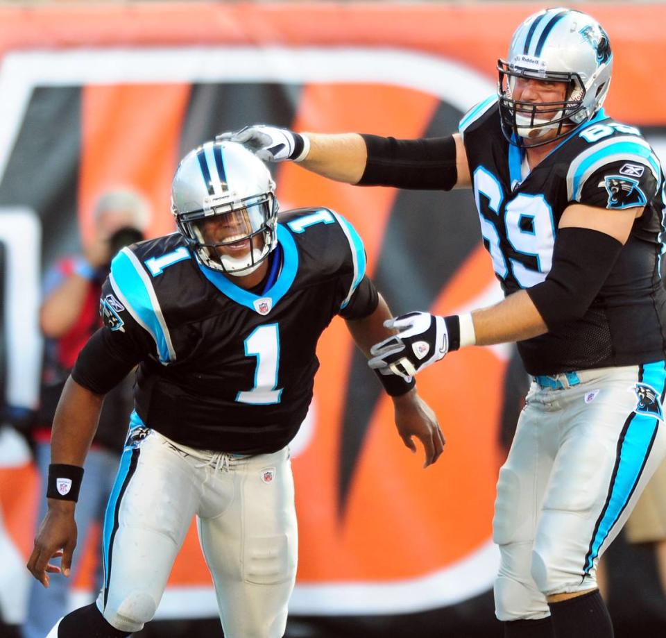 In 2011, Panthers rookie quarterback (1) Cam Newton is congratulated by teammate Jordan Gross after Newton rushed for a touchdown.