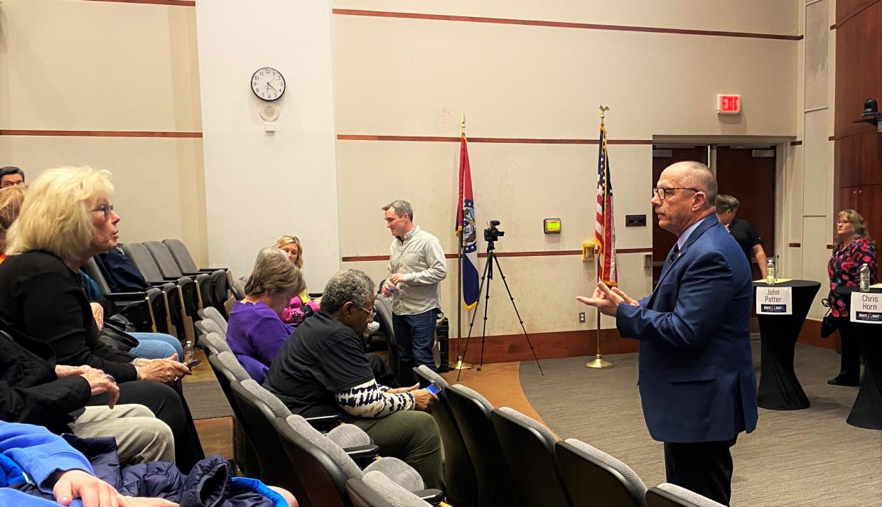 School board candidate Chuck Basye talks with supporters on March 20, 2023, before the start of a candidate forum in Cornell Hall at the University of Missouri.