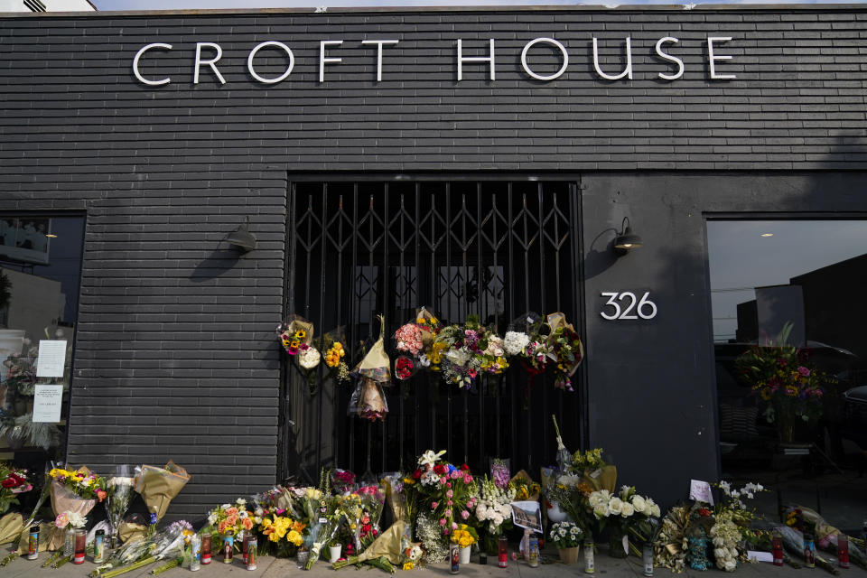 Flowers and candles are placed outside Croft House store in honor of Brianna Kupfer on Tuesday, Jan. 18, 2022, in Los Angeles. The Los Angeles Police Department, West Bureau Homicide detectives are investigating the murder of Kupfer, a 24-year-old Pacific Palisades resident, who was killed at a business in the 300 block of North La Brea Avenue on Jan. 13. (AP Photo/Ashley Landis)