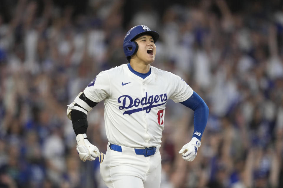 Los Angeles Dodgers' Shohei Ohtani reacts after hitting a three-run home run during the second inning in Game 1 of baseball's NL Division Series against the San Diego Padres, Saturday, Oct. 5, 2024, in Los Angeles. (AP Photo/Mark J. Terrill)