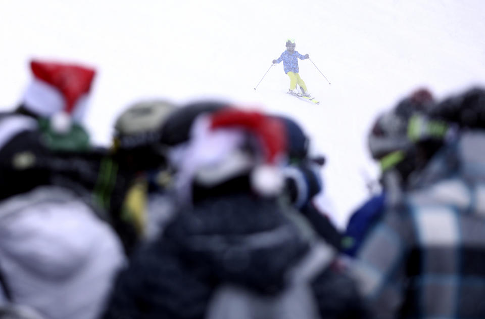 Skiers ski on the slopes of Mount Jahorina, 30 kilometers south of the Bosnian capital of Sarajevo, Saturday, Dec. 11, 2021. As most of Europe reintroduces measures to help curb the spread of the omicron variant, Bosnia, to the delight of its winter tourism industry, still maintains a relatively laissez-fair approach to the soaring COVID-19 infection numbers across the continent. (AP Photo/Marjan Vucetic)