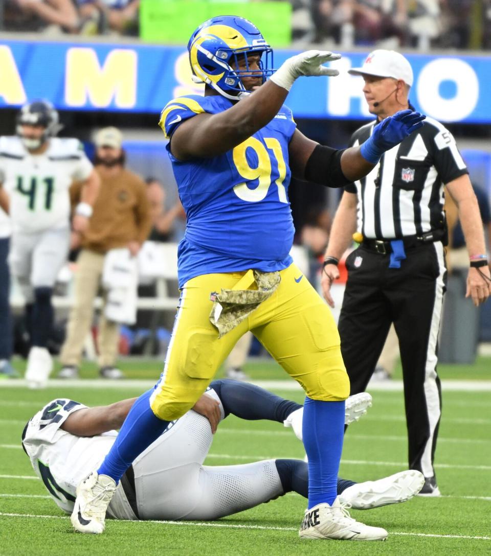 Rams' Kobie Turner celebrates a play against Seattle Seahawks' Geno Smith.