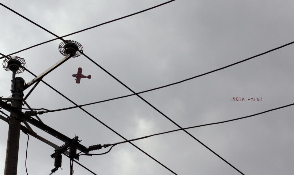 An airplane flies a banner with a message that reads in Spanish: "Vote for the FMLN", over a closing presidential campaign rally, in San Salvador, El Salvador, Sunday, Jan. 27, 2019, ahead of next Sunday's election. The FMLN, which stands for the Farabundo Marti National Liberation Front, is a rebel-group-turned-political-party which currently holds the presidency. (AP Photo/Salvador Melendez)