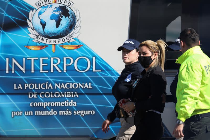 Colombian National Police officers escort Nini Johana Usuga, alias 'La Negra', at the Military Transport Air Command (CATAM) in Bogota