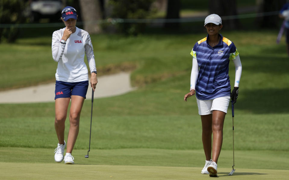 Aditi Ashok, of India, right, and Nelly Korda, of the United States, walk on the 18th green during the third round of the women's golf event at the 2020 Summer Olympics, Friday, Aug. 6, 2021, at the Kasumigaseki Country Club in Kawagoe, Japan. (AP Photo/Darron Cummings)