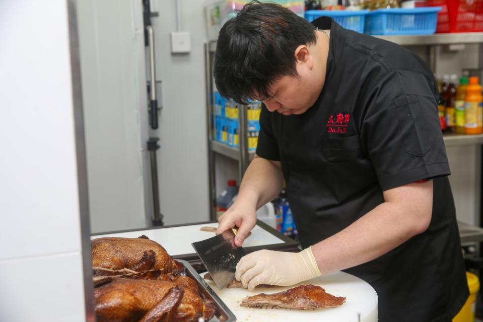 The braised duck is cut just before serving.