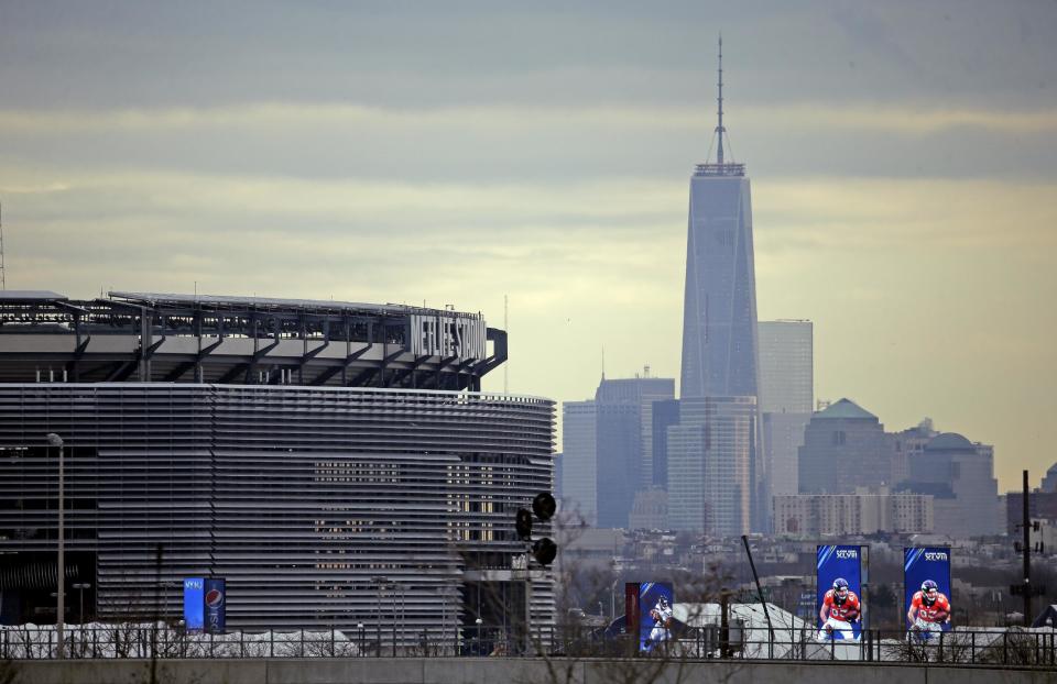 MetLife Stadium is seen in the foreground with the New York city skyline Monday, Jan. 27, 2014, before the NFL Super Bowl XLVIII football game in East Rutherford, N.J. (AP Photo/Charlie Riedel)