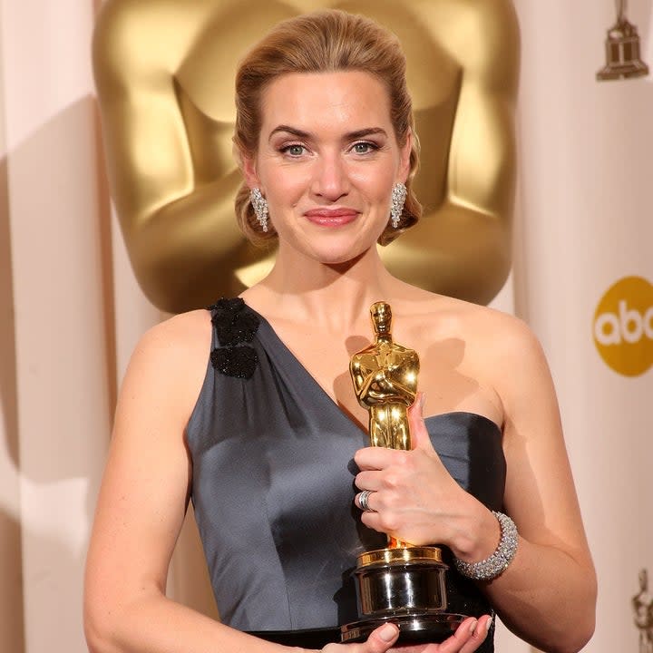 Kate Winslet holds an Academy Award